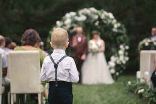 Kind blickt auf Brautpaar bei Hochzeitskinderbetreuung